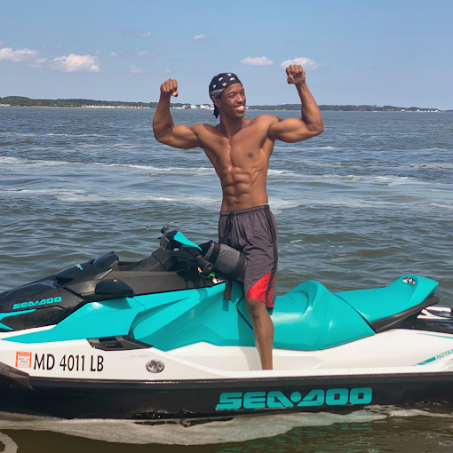 Rider standing on a jet ski flexing — real rider freedom on the OC bay