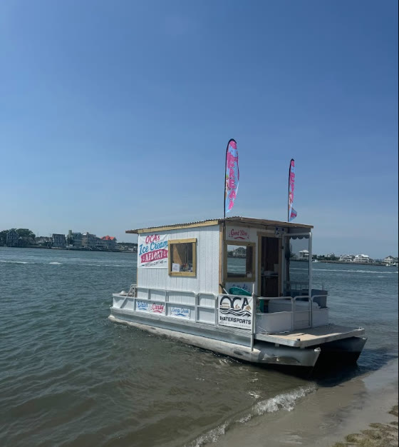 The Ice Cream Afloat pontoon boat posted up on the beach at Assateague