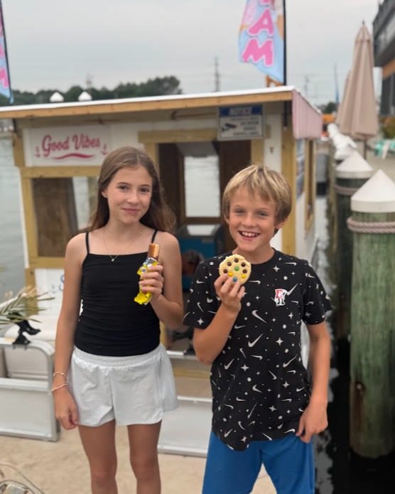 Two happy kids holding frozen treats from the Ice Cream Afloat boat