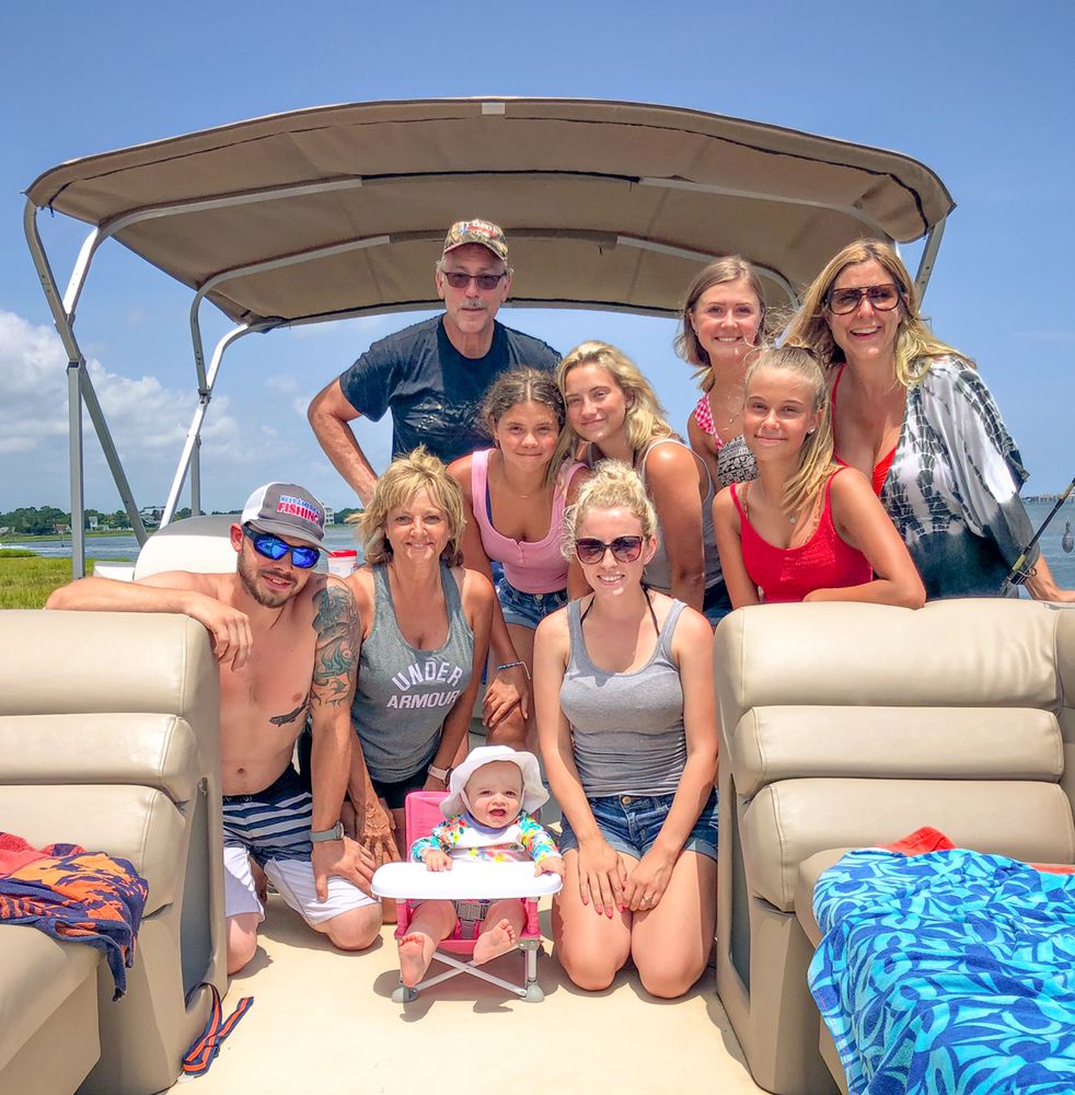 Big family smiling together on a pontoon boat rental in Ocean City MD