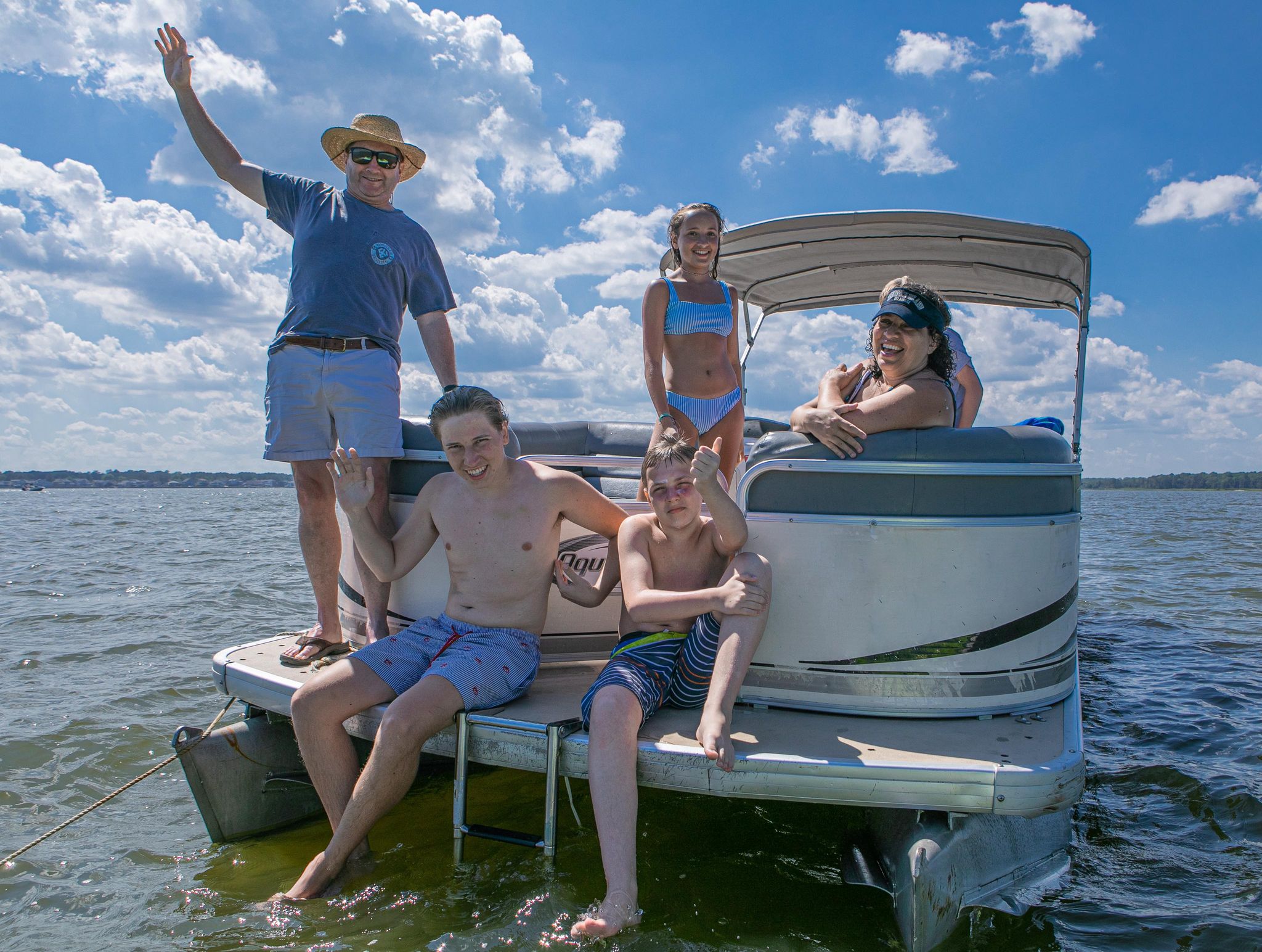 Family fishing on a pontoon boat